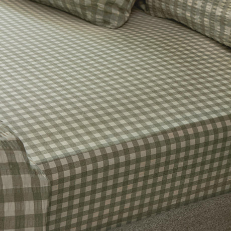 Harriet Gingham Check Cotton Fitted Sheet in Baygreen/Mist, showing the sage-and-cream check pattern and textured cotton weave fitted over a mattress corner.