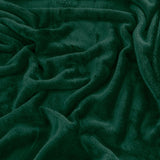 Close-up of the Harrow Plain Polyester Throw in emerald green, showing its dense, short flannel fleece pile with soft folds and no border or pattern.