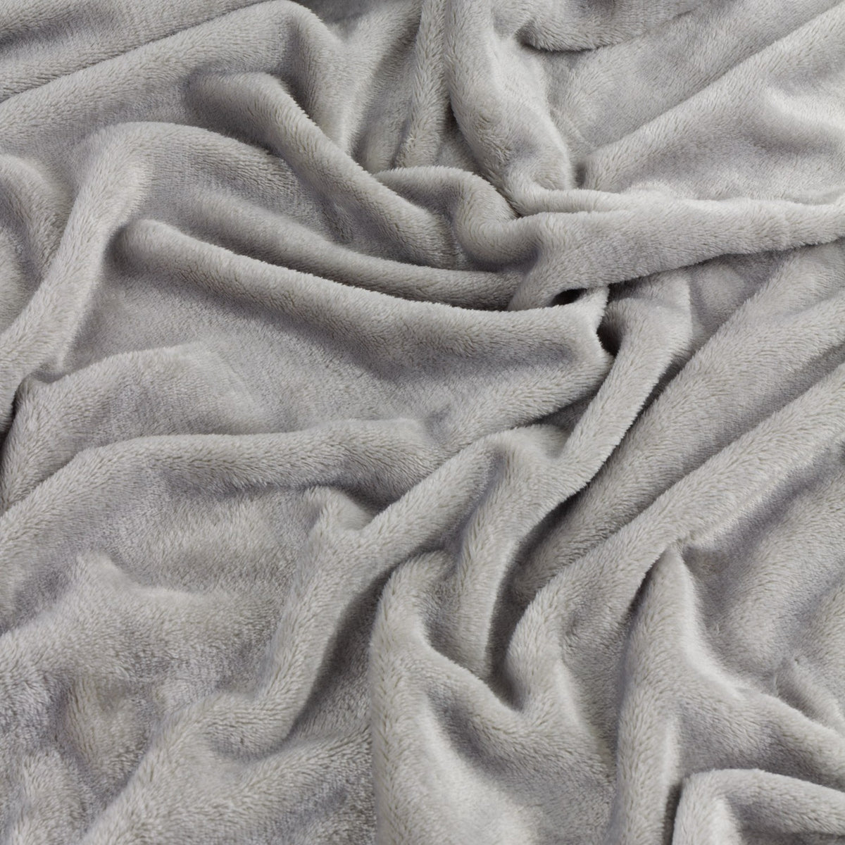 Close-up of the Harrow Plain Polyester Throw in grey, showing its soft, brushed flannel fleece texture folded into gentle waves.
