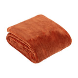 Harrow Plain Polyester Throw in rust orange, folded into a square with visible plush flannel fleece texture, shown on a plain white background.