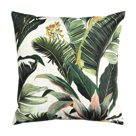 Square Hawaii Jungle polyester cushion with a pale ground and layered green tropical leaf print, amber-gold flowers and coral-pink stems, shown on a plain white background.