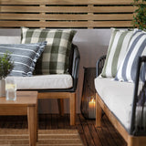 Hayle Reversible Cotton Cushion in navy and white wide stripe, square 50 x 50cm, styled on an outdoor sofa alongside striped and check cushions on a wooden deck.