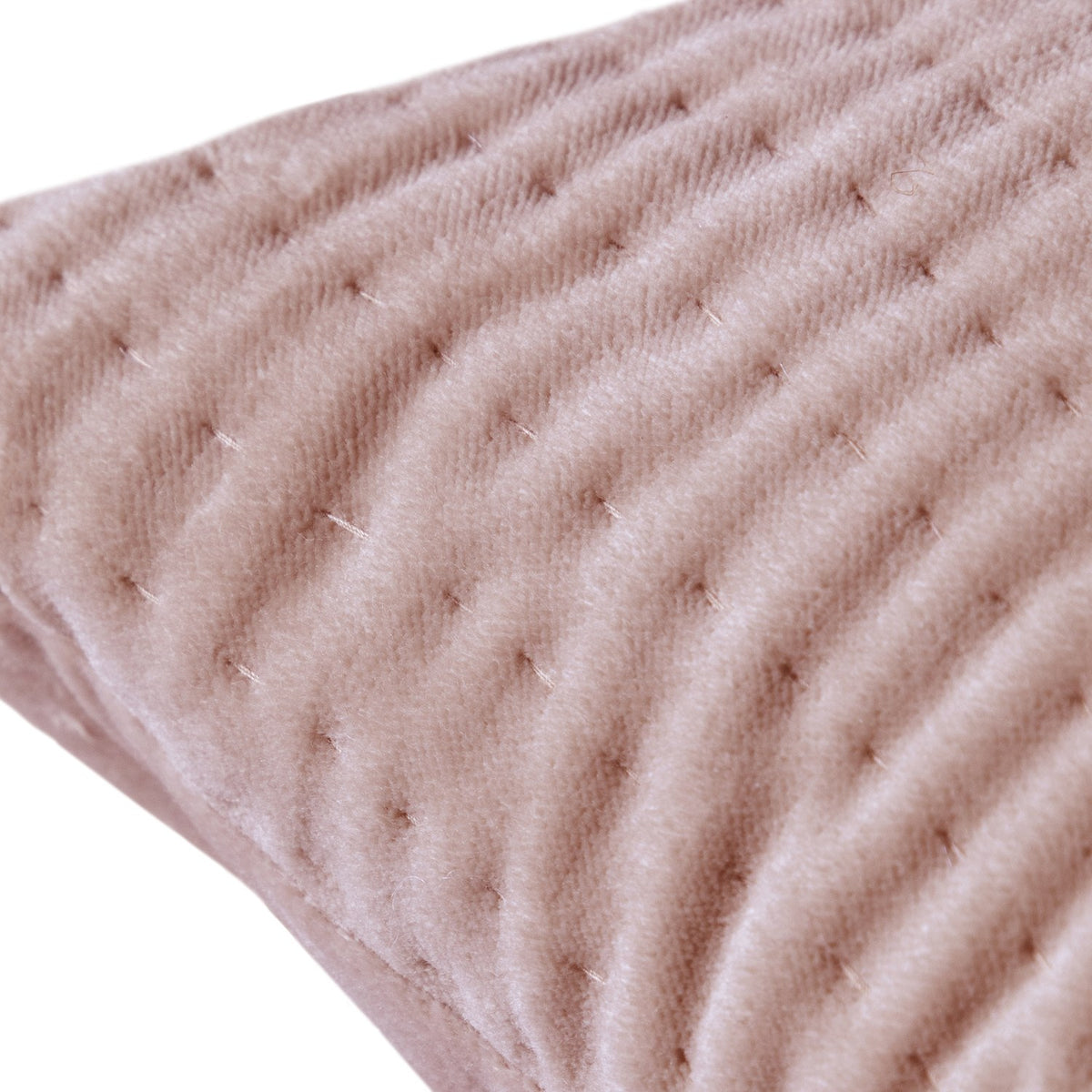 Close-up of the Haze Plain Velvet Cushion in coral, showing a quilted wave-stitched velvet surface in soft ridges on a plain background.