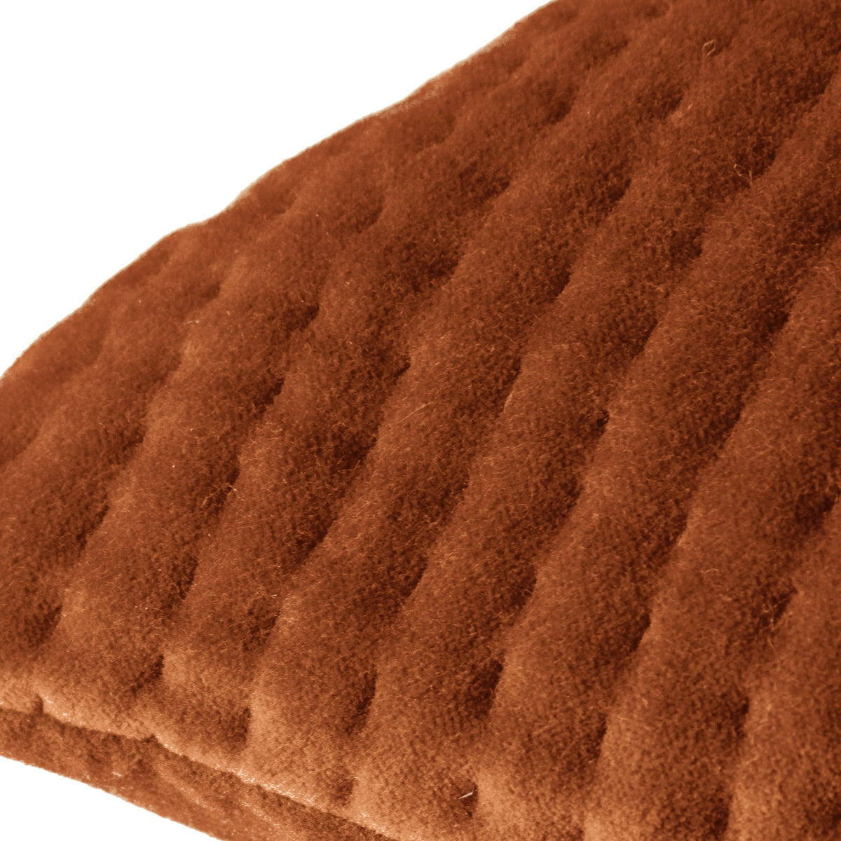 Close-up of the Haze Plain Velvet Cushion in Sunset, showing rust-orange velvet with fine quilted ridges creating a rippled texture, on a plain white background.