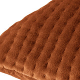 Close-up of the Haze Plain Velvet Cushion in Sunset, showing rust-orange velvet with fine quilted ridges creating a rippled texture, on a plain white background.