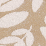 Close-up of the Hazel Botanical Polyester Throw in oatmeal, showing a woven leaf pattern in soft white against a beige textured ground.