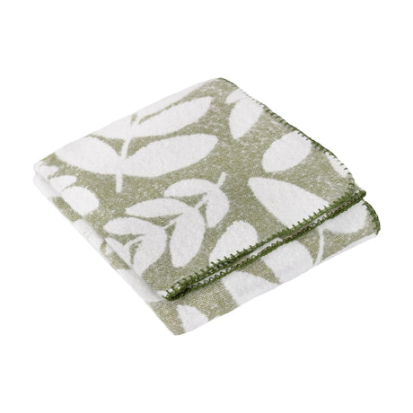 Hazel Botanical Polyester Throw in olive green, folded showing a white leaf pattern with a green whip-stitched edge, on a plain white background.