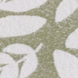 Close-up of the Hazel Botanical Polyester Throw in olive, showing a woven leaf pattern in white against a green ground.