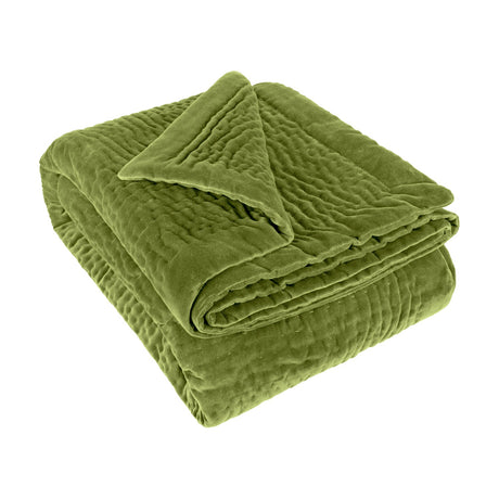 Haze Velvet Cotton Throw in grass green, folded to show hand-quilted rippled texture with a smooth velvet border, on a plain white background.