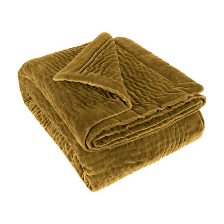 Haze Velvet Cotton Throw in mustard, folded to show a hand-quilted, rippled cotton velvet texture, shown on a plain white background.