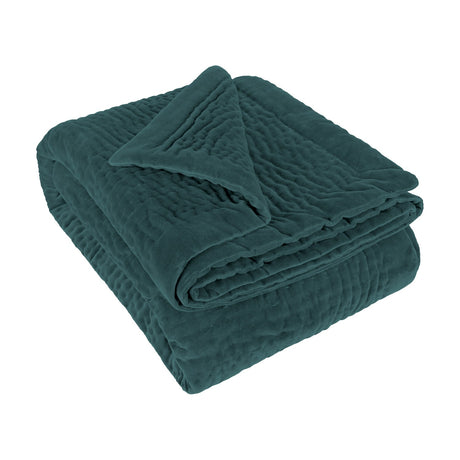 Haze Velvet Cotton Throw in Ocean teal, folded to show its hand-quilted rippled texture and velvet cotton finish, on a plain white background.