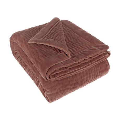 Haze Velvet Cotton Throw in persimmon, hand-quilted with rippled texture, folded on a plain white background.