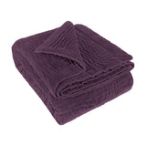 Haze Velvet Cotton Throw in Plum, folded to show hand-quilted rippled texture on a soft velvet finish, set against a plain white background.