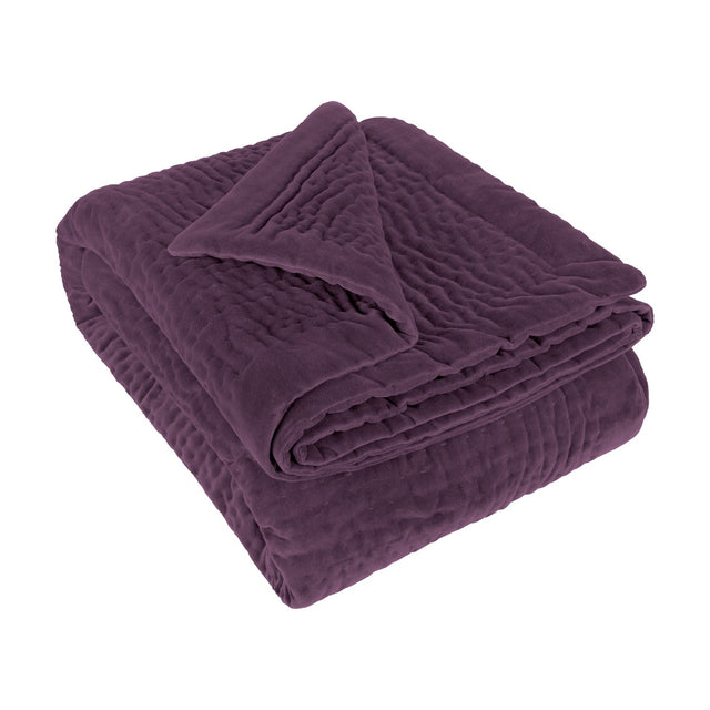 Haze Velvet Cotton Throw in Plum, folded to show hand-quilted rippled texture on a soft velvet finish, set against a plain white background.
