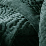 Close-up of the Haze Velvet Cotton Throw in seafoam green, showing hand-quilted cotton velvet with a bubbled texture and folded seam detail.