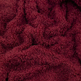 Close-up of the Harlan Borg Sherpa Plain Polyester Throw in burgundy, showing its dense, curly textured pile fabric.