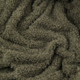 Close-up of the Harlan Borg Sherpa Plain Polyester Throw in olive green, showing its dense, curly-piled fleece texture draped in loose folds.