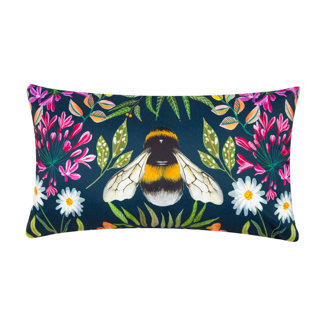 Rectangular navy polyester scatter cushion with a hand-painted bumble bee at its centre, surrounded by pink honeysuckle, white daisies and green foliage, shown on a plain white background.