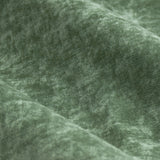 Close-up of heavy chenille velvet eyelet curtain fabric in eucalyptus green, showing soft rounded folds and a subtle textured sheen.