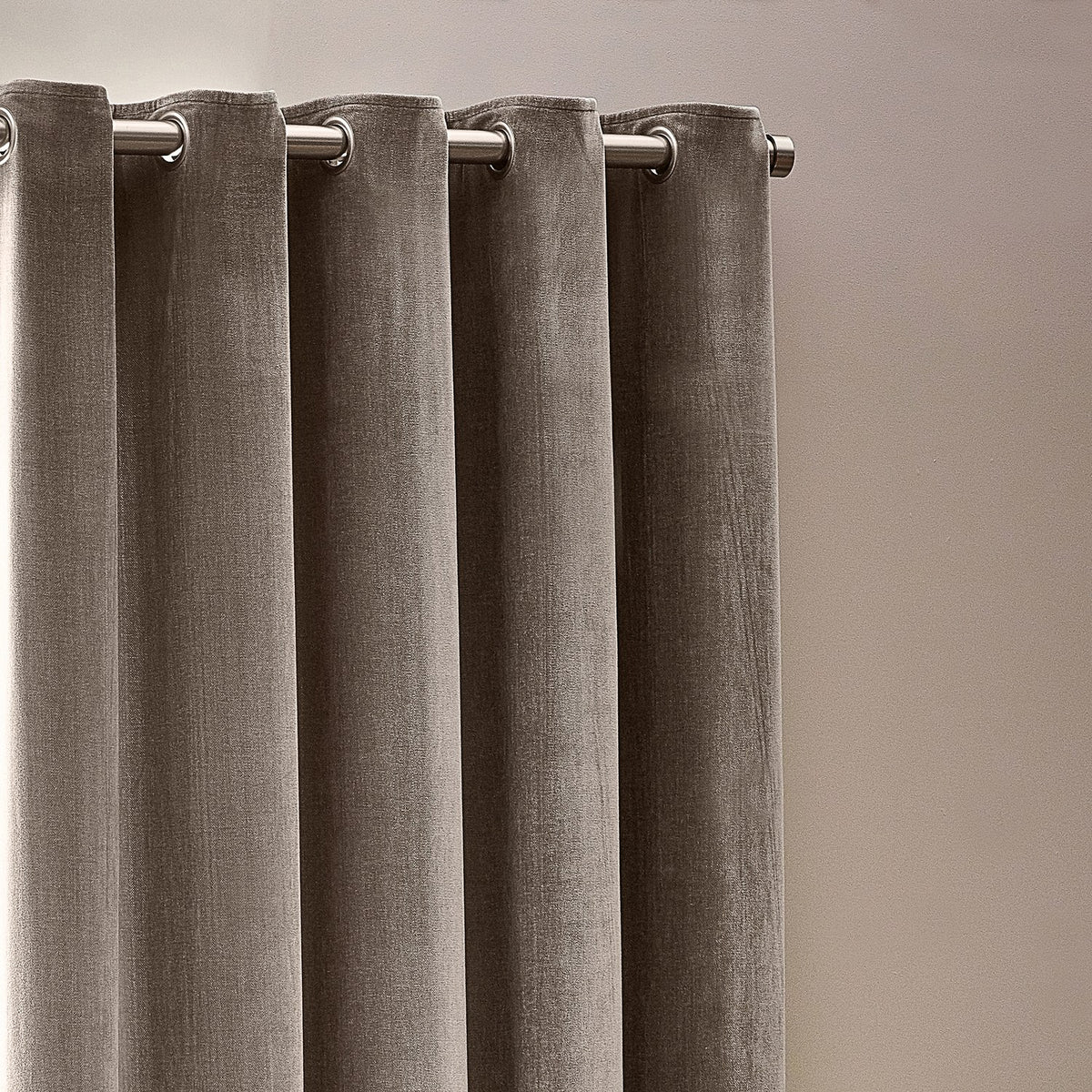 Heavy Chenille Velvet Lined Eyelet Curtains in greige, close-up of silver eyelet rings on a metal rod against a neutral wall.