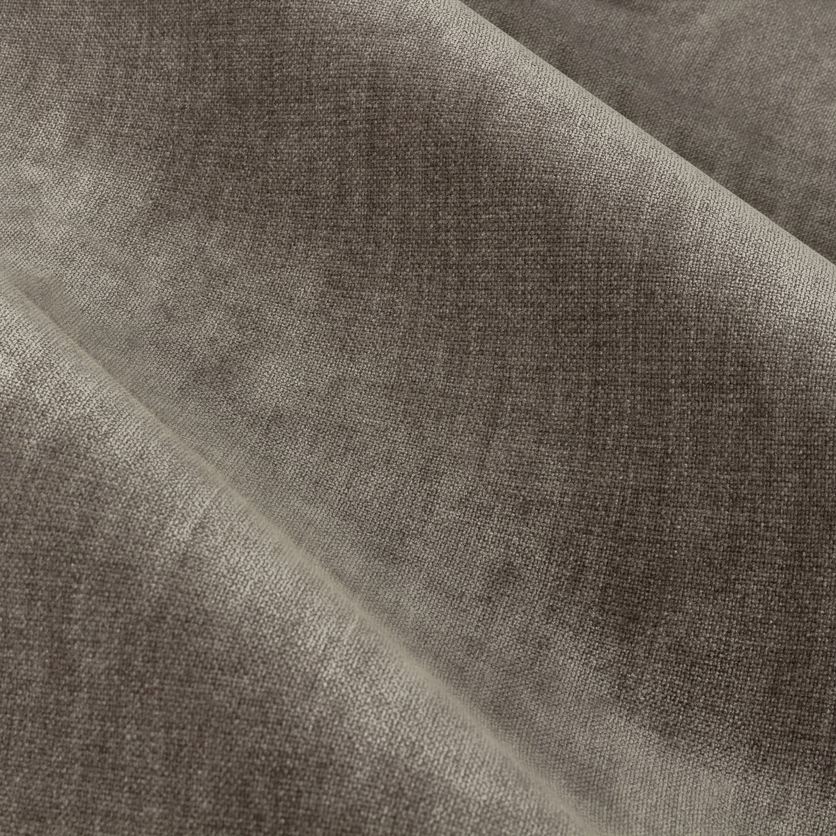 Close-up of heavy chenille velvet eyelet curtain fabric in greige, showing soft draped folds with a subtle sheen and woven polyester texture.