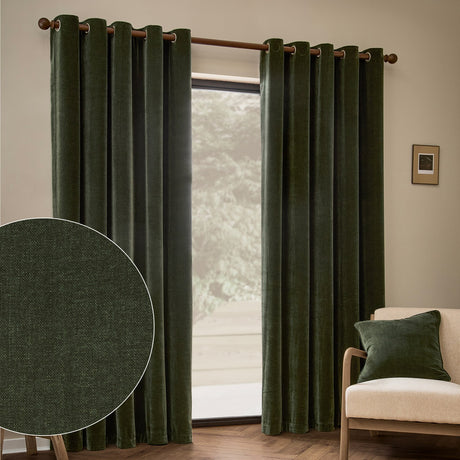Heavy chenille velvet eyelet curtains in lichen green hanging on a wooden pole in a living room, with a fabric close-up inset and beige armchair nearby.