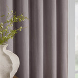 Heavy chenille velvet fully lined eyelet curtains in muted mauve, shown close-up with soft folds beside a window, styled with a white vase and greenery.