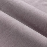 Close-up of heavy chenille velvet fabric from the eyelet curtains in soft, dusty mauve, showing the soft, matt pile weave texture in a draped fold.