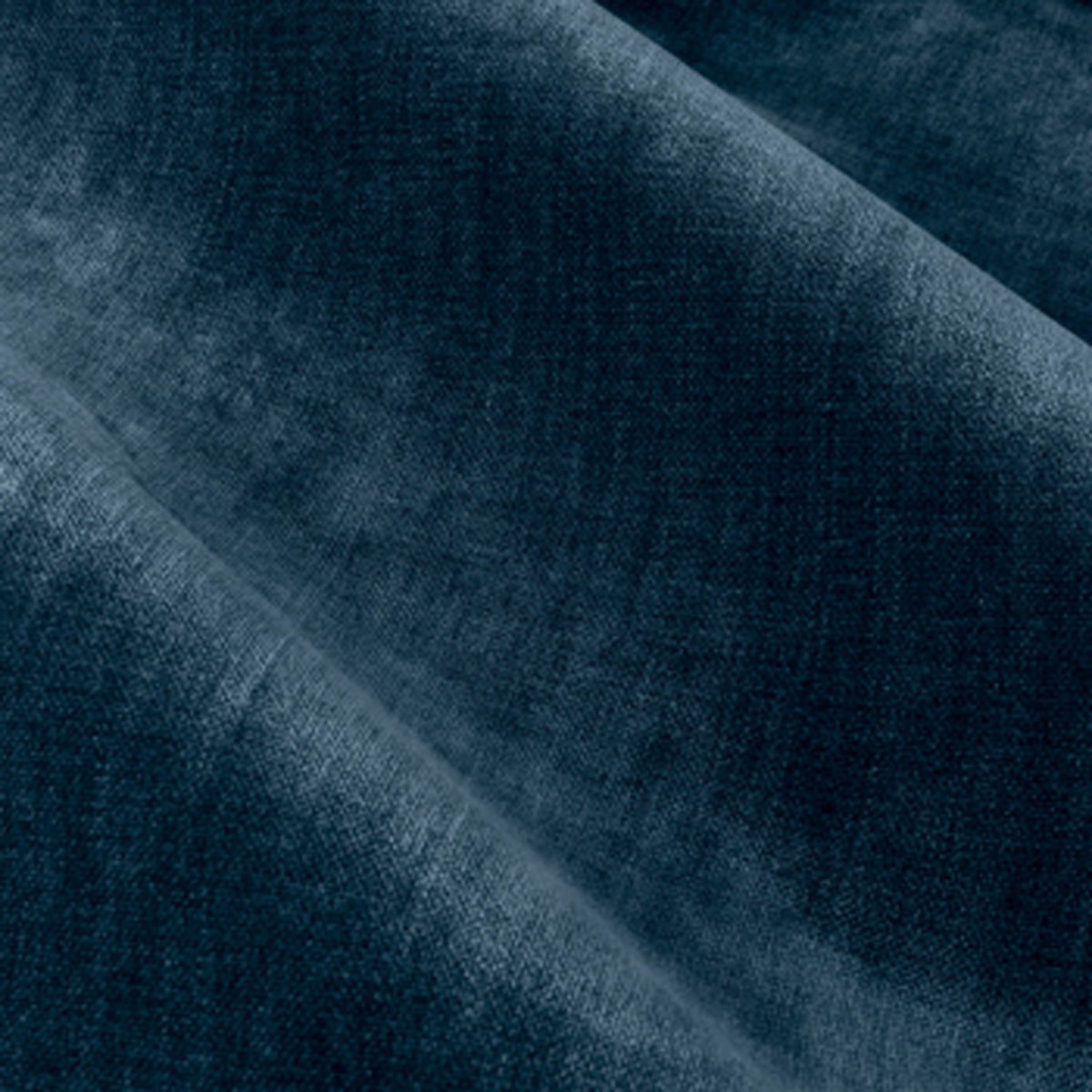 Close-up of heavy chenille velvet eyelet curtain fabric in deep navy, showing soft draped folds and a dense pile with subtle sheen variations.