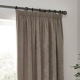 Heavy Chenille Plain Velvet Pencil Pleat Curtains in greige, hung on a dark metal pole with pencil pleat heading, shown draping in soft folds by a window.