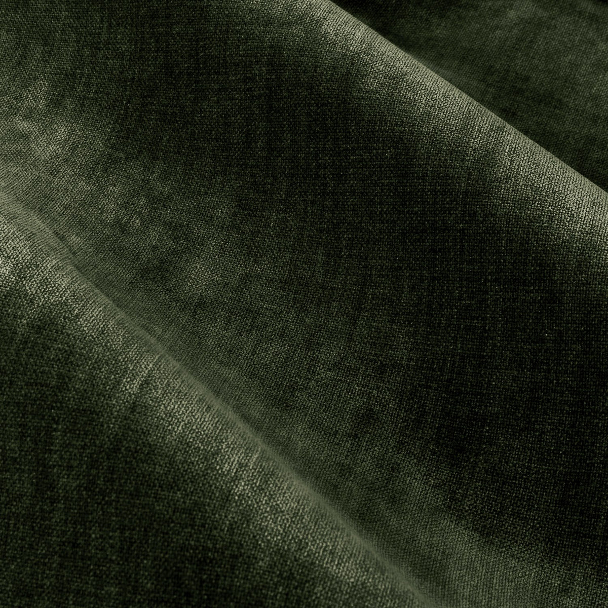 Close-up of the heavyweight chenille velvet fabric on the Pencil Pleat Curtains in lichen green, showing draped folds with light catching the plush pile.