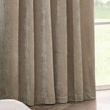 Pencil pleat curtains in natural beige heavy chenille velvet, shown floor-length with soft folds beside a window overlooking a garden.