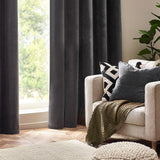 Charcoal Heavy Chenille Velvet Cushion with piped trim styled on a beige armchair alongside a patterned cushion and olive throw in a living room setting.