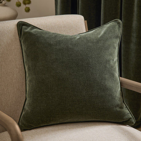Heavy Chenille Plain Velvet Cushion in lichen green, square with piped edges, shown on a beige armchair in a living room setting.