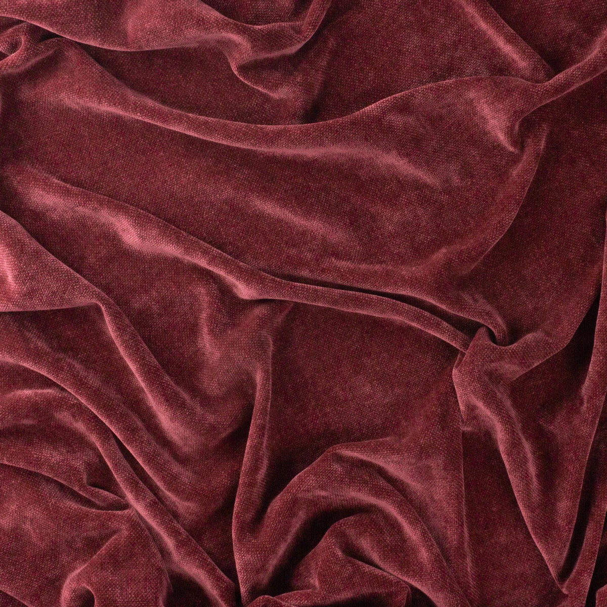 Heavy Chenille Eyelet Velvet Throw in beetroot red, softly draped fabric showing a mottled, wine-dark sheen across its velvet pile.