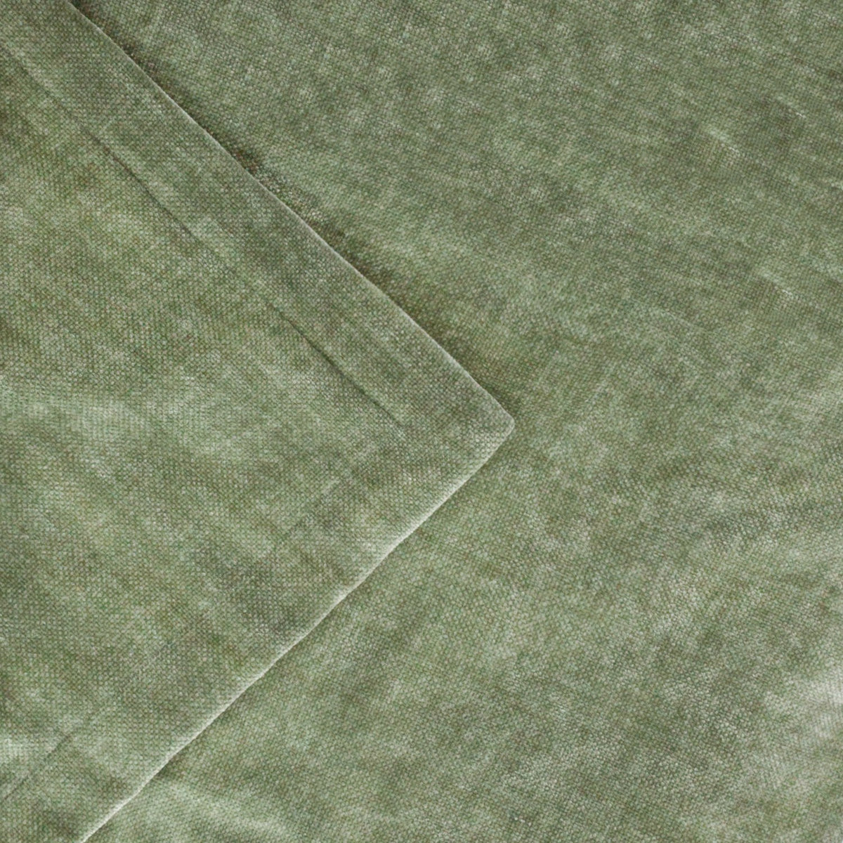 Close-up of the Heavy Chenille Eyelet Velvet Throw in eucalyptus green, showing the dense chenille pile texture and folded edge in a mottled polyester weave.