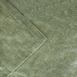 Close-up of the Heavy Chenille Eyelet Velvet Throw in eucalyptus green, showing the dense chenille pile texture and folded edge in a mottled polyester weave.