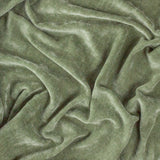 Close-up of the Heavy Chenille Eyelet Velvet Throw in eucalyptus green, showing its dense, brushed velvet texture with folds revealing lighter and darker tonal variation.