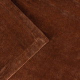 Close-up of the Heavy Chenille Eyelet Velvet Throw in nutmeg brown, showing folded fabric with a soft tufted pile and subtle sheen variation across the surface.