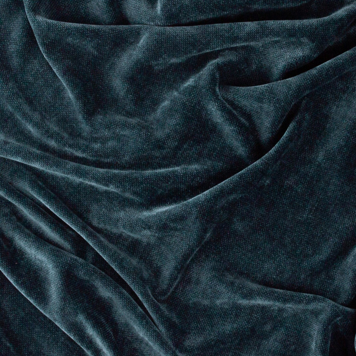 Close-up of the Heavy Chenille Eyelet Velvet Throw in navy, showing the dense velvet nap and soft folds with light catching the fabric's texture.