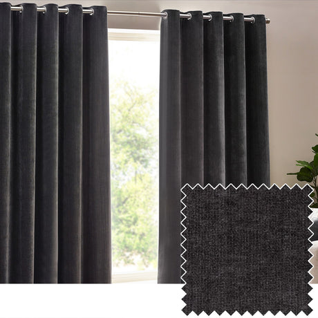 Heavy chenille velvet eyelet curtains in charcoal hanging in folds from a chrome pole beside a window, with a fabric swatch shown in the corner.