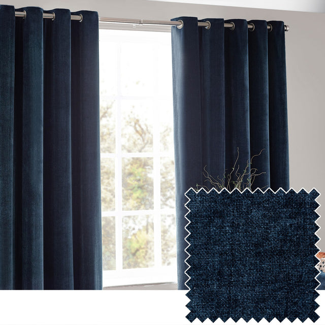 Navy chenille velvet eyelet curtains hanging in full folds on a chrome rod by a window, with a fabric swatch showing the textured weave inset.