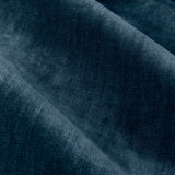Close-up of heavy chenille velvet eyelet curtain fabric in deep navy blue, showing soft rounded folds and light catching the pile texture.