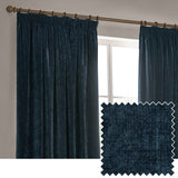 Navy blue heavy chenille velvet pencil pleat curtains hanging from a wooden pole beside a window, shown with a fabric swatch close-up in a neutral room setting.