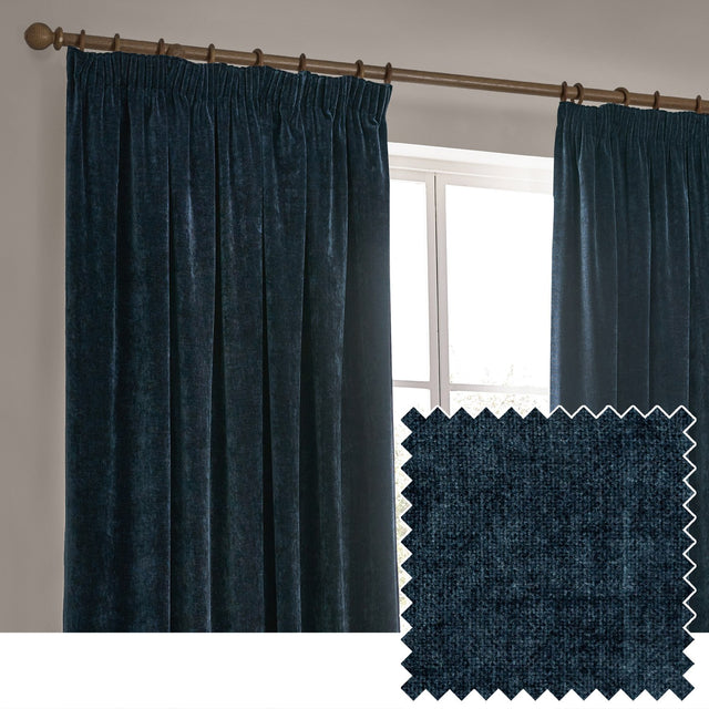 Navy blue heavy chenille velvet pencil pleat curtains hanging from a wooden pole beside a window, shown with a fabric swatch close-up in a neutral room setting.