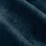 Close-up of heavy chenille velvet pencil pleat curtain fabric in deep navy blue, showing a dense plush pile with soft, uneven light reflection and draped folds.