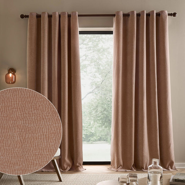 Heath Washed Velvet Jacquard Fully Lined Eyelet Curtains in Cotta pink hung on a dark rod by a window, with a fabric texture close-up shown in the corner.