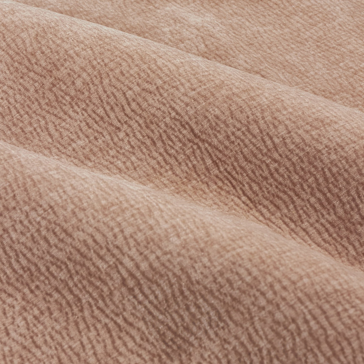 Close-up of Heath eyelet curtain fabric in dusty pink, showing a washed velvet jacquard weave with a soft, textured grain and gentle folds.