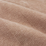 Close-up of Heath eyelet curtain fabric in dusty pink, showing a washed velvet jacquard weave with a soft, textured grain and gentle folds.