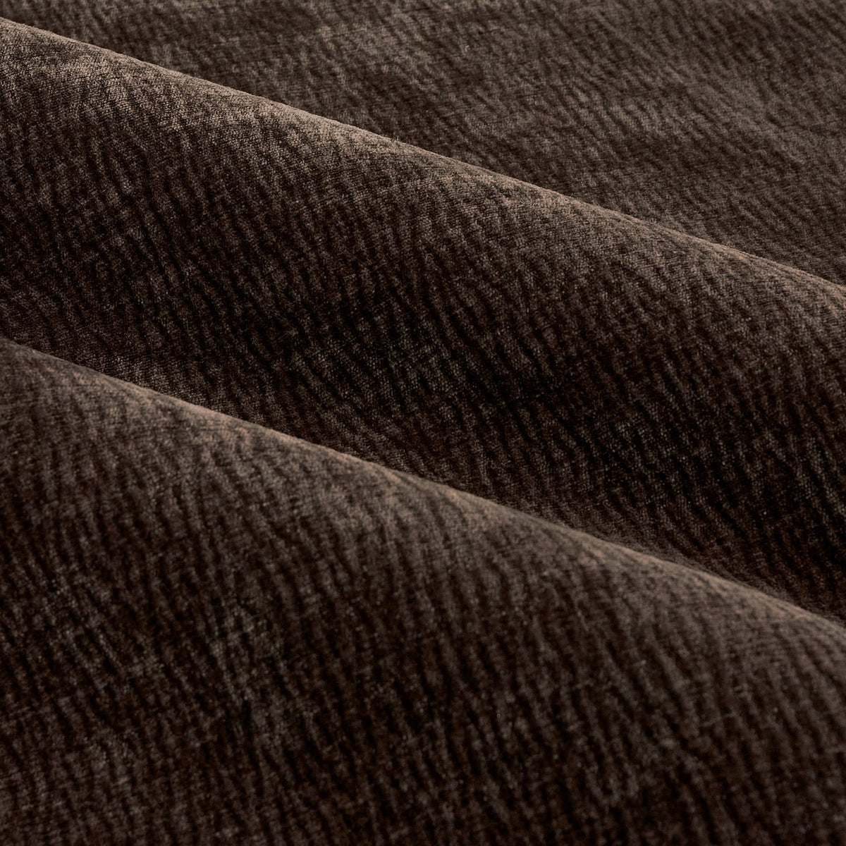 Close-up of Heath eyelet curtain fabric in espresso brown washed velvet, showing soft folds and a subtle jacquard-textured weave.